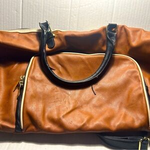 Woman’s brown unbranded shoulder duffel travel bag